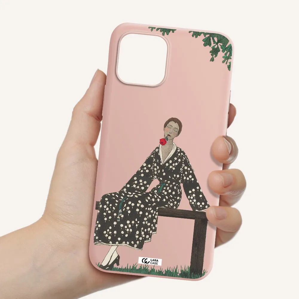 a woman sitting on a bench Apple iPhone 12 Silicone pastel pink Case