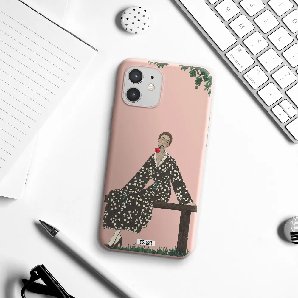 a woman sitting on a bench Apple iPhone 12 Silicone pastel pink Case