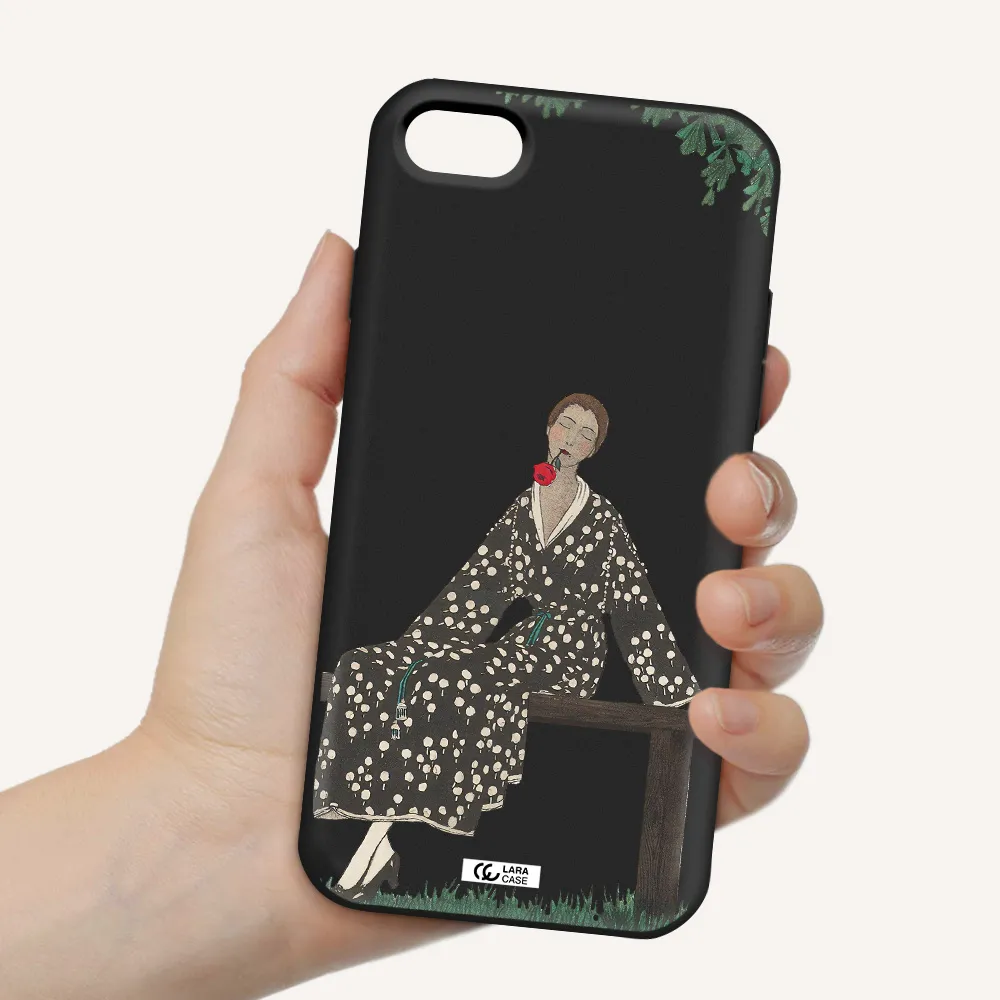 a woman sitting on a bench Apple iPhone 8 Silicone black Case