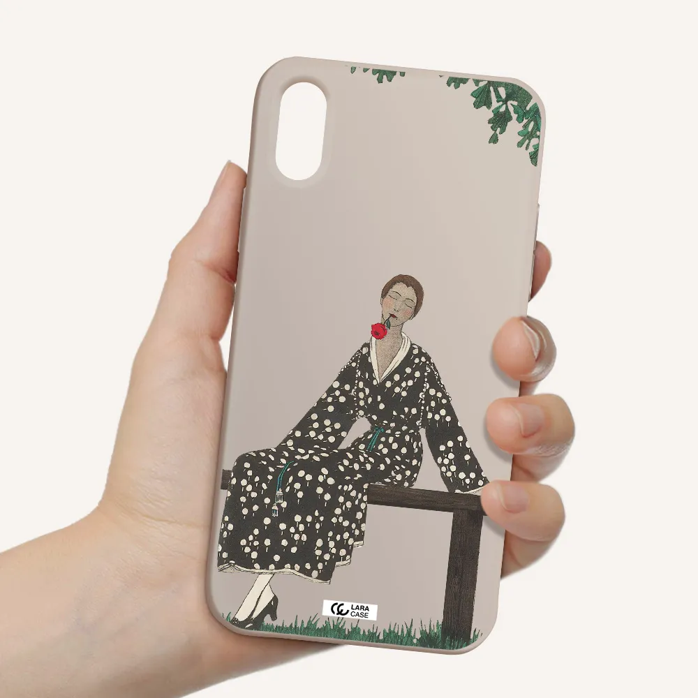 a woman sitting on a bench Apple iPhone X Silicone Stone Case