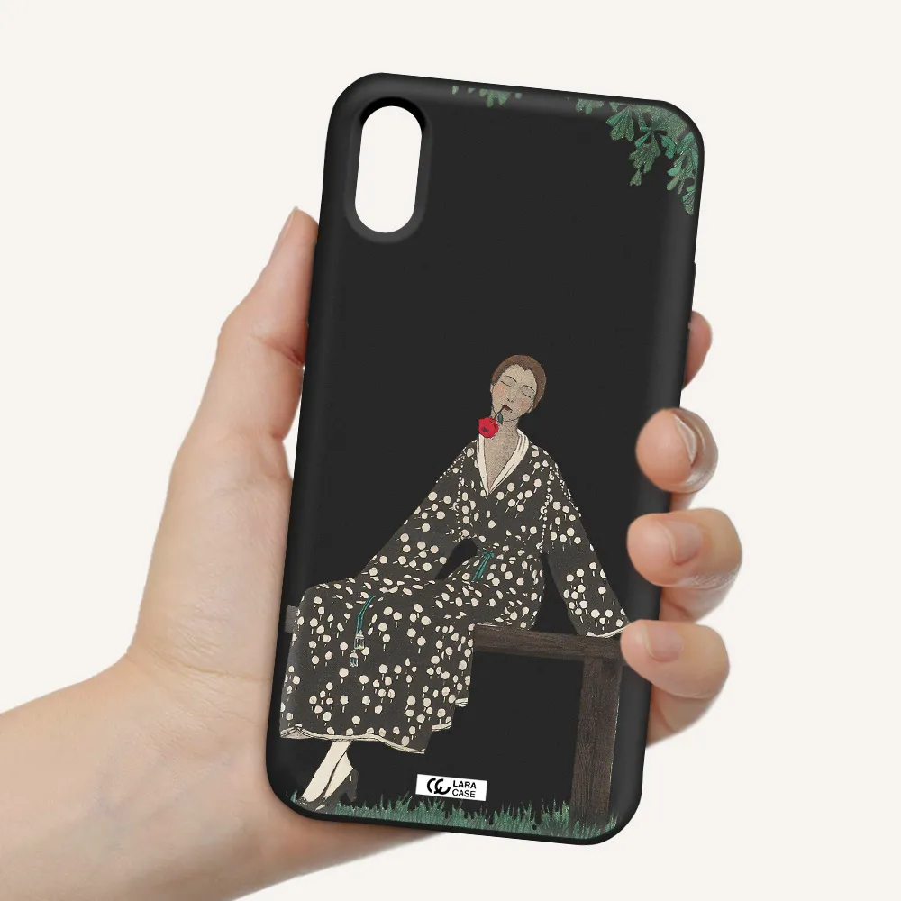 a woman sitting on a bench Apple iPhone XS Silicone black Case