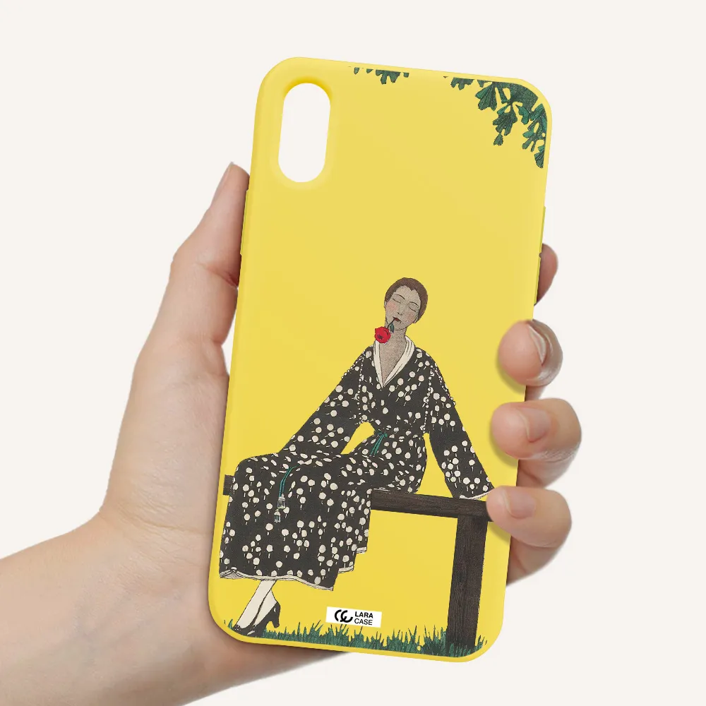 a woman sitting on a bench Apple iPhone XS Silicone canary yellow Case