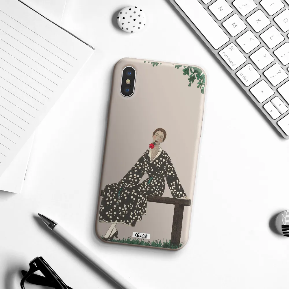 a woman sitting on a bench Apple iPhone XS Silicone Stone Case