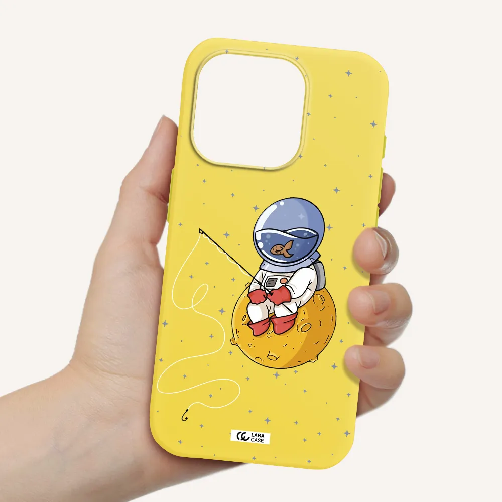 A Cartoon Of An Astronaut Sitting On A Moon Apple Iphone 15 Pro Silicone Canary Yellow Case