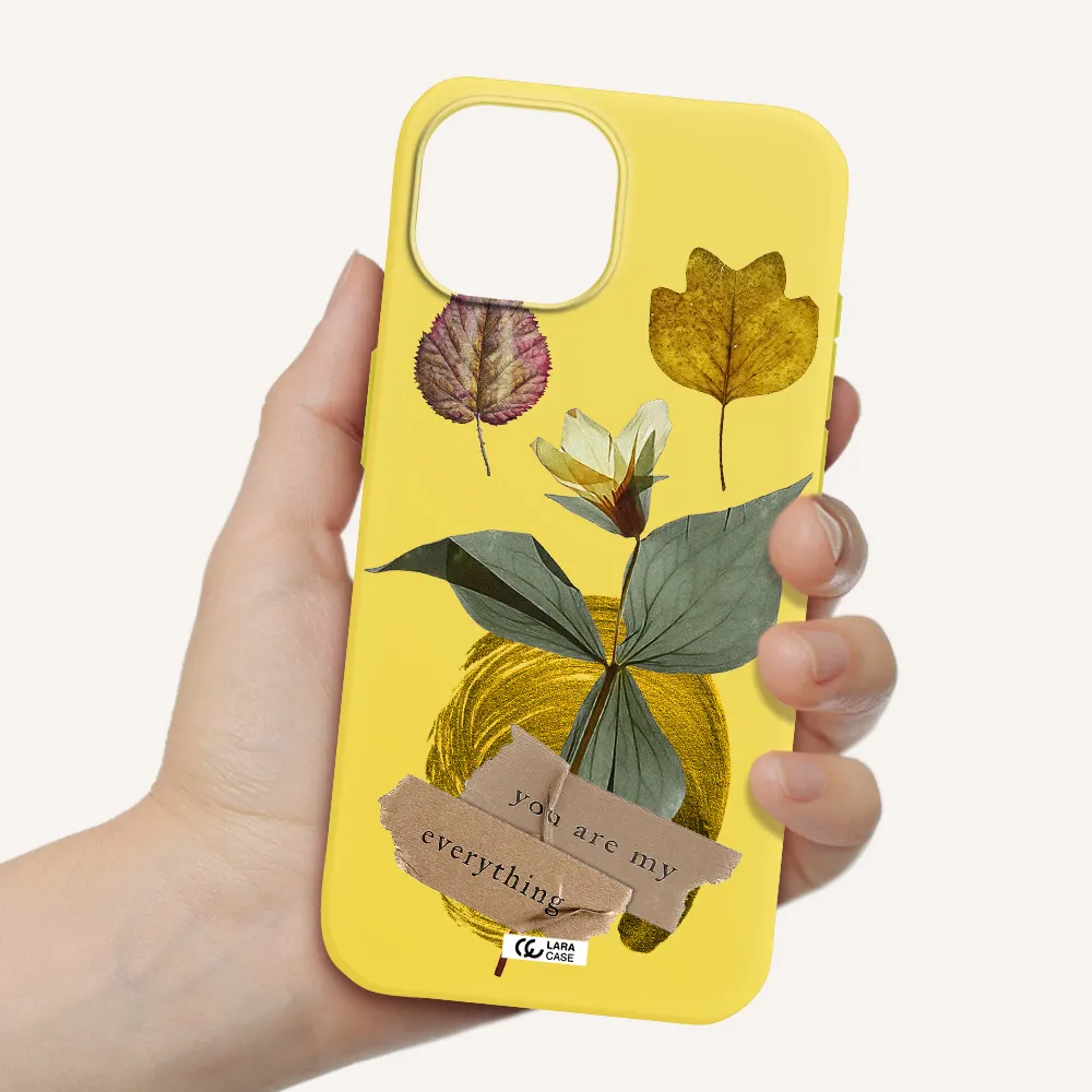 a flower with leaves and a box Apple iPhone 15 Silicone canary yellow Case