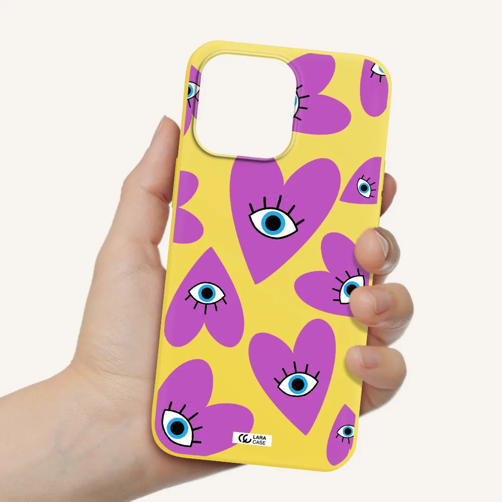 a purple heart with eyes and a black eye Apple iPhone 14 pro max Silicone canary yellow Case