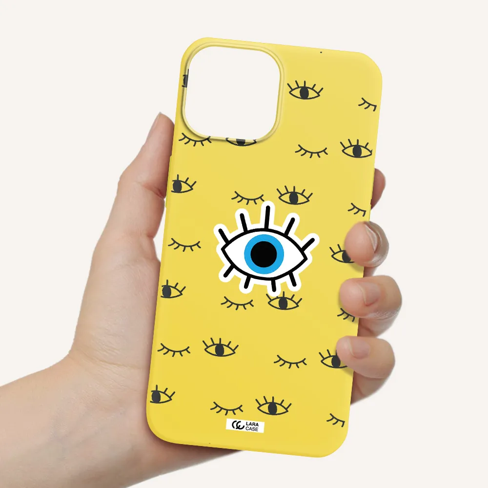 a blue eye with black eyeballs and eyelashes Apple iPhone 13 Silicone canary yellow Case