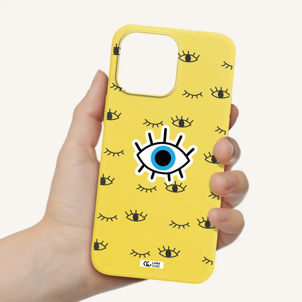 a blue eye with black eyeballs and eyelashes Apple iPhone 14 pro max Silicone canary yellow Case