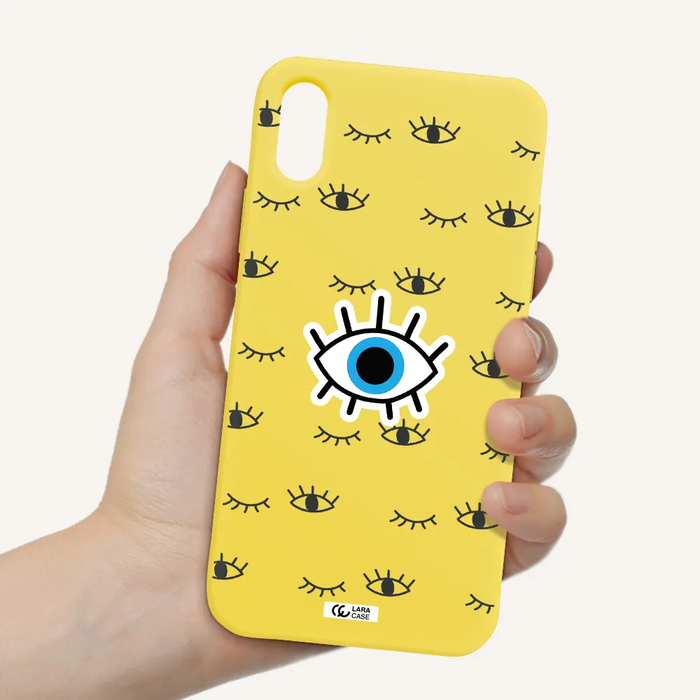 a blue eye with black eyeballs and eyelashes Apple iPhone X Silicone canary yellow Case